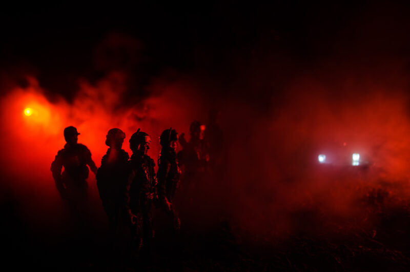 Anti-riot police give signal to be ready Government power concept Police in action Smoke on a dark background with lights Blue red flashing sirens