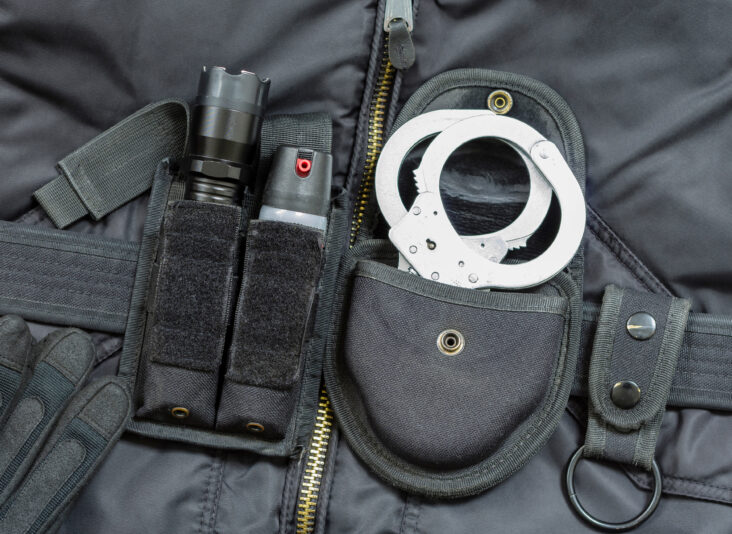 Police equipment Metal handcuffs and tear gas spray
