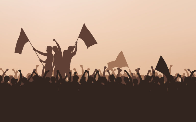Silhouette group of protesters people Raised Fist and flags in flat icon design with evening sky background