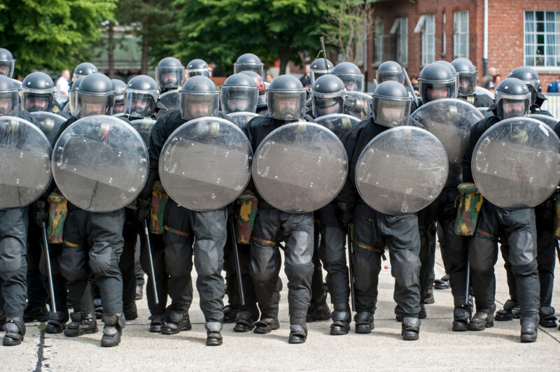 Leopoldsburg Belgium May 2011 Demonstration of riot squad forming a protective barrier with riot shields